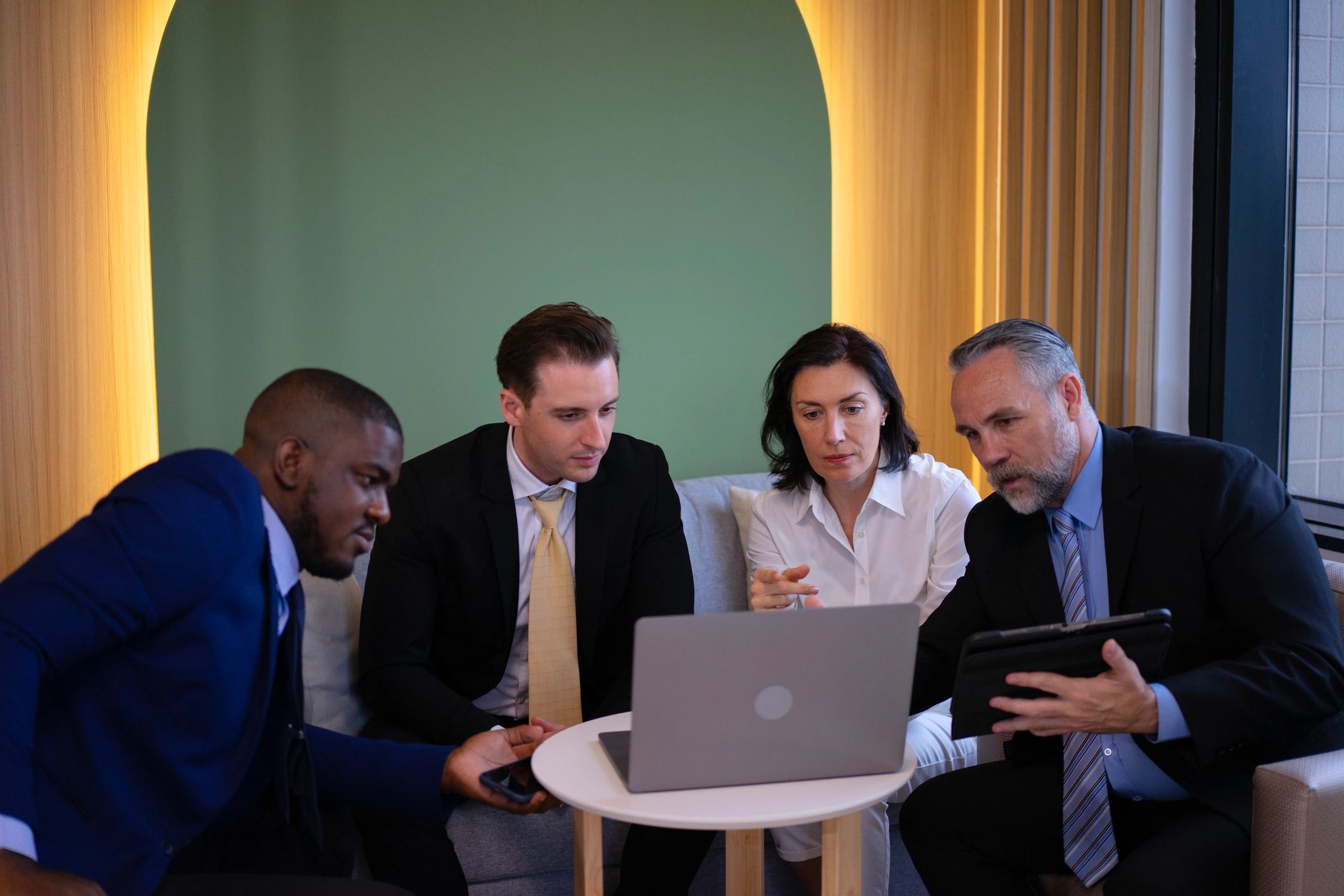 Professional advisory team in discussion during a legal and compliance consultation