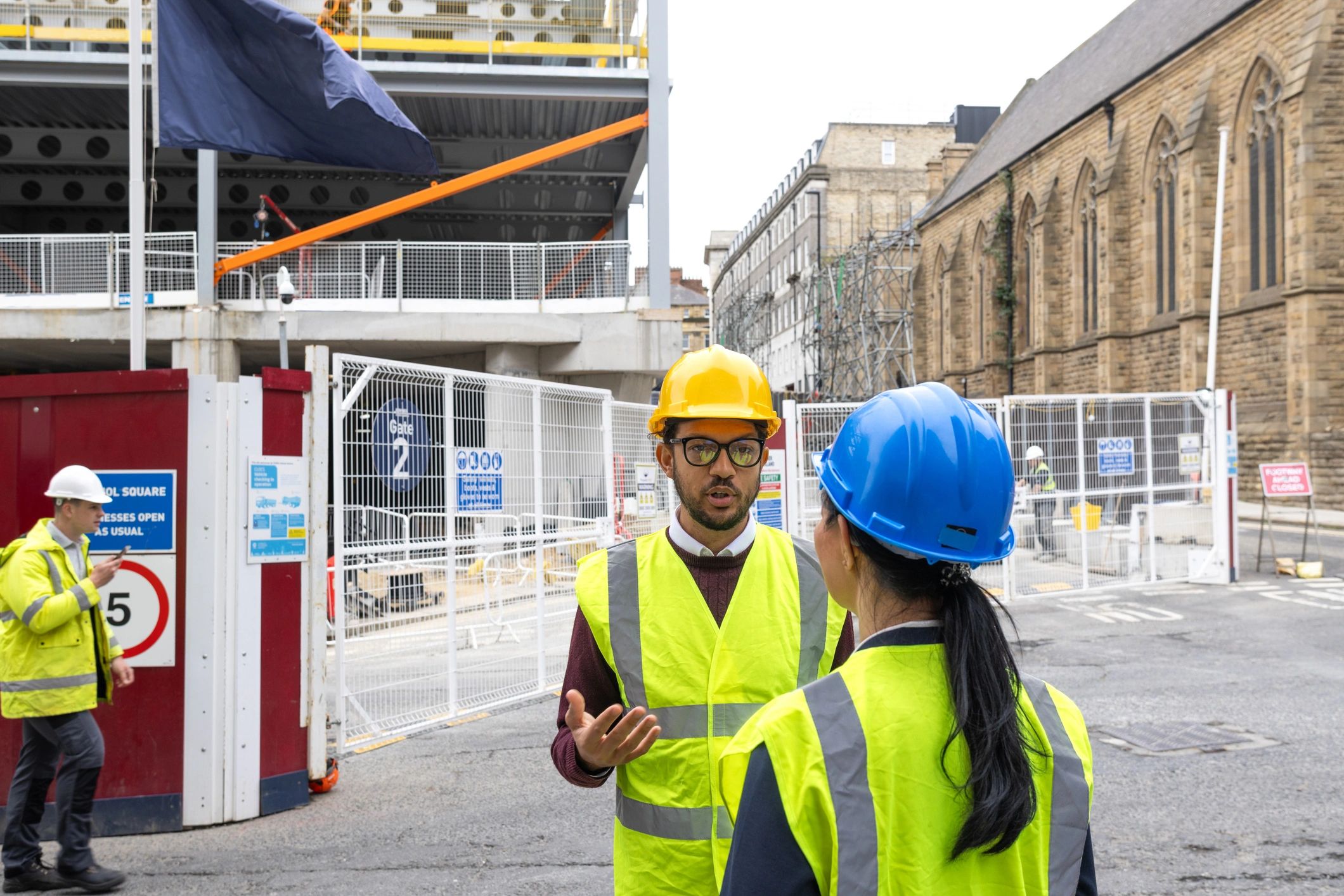 Construction professionals reviewing plans at an infrastructure project site